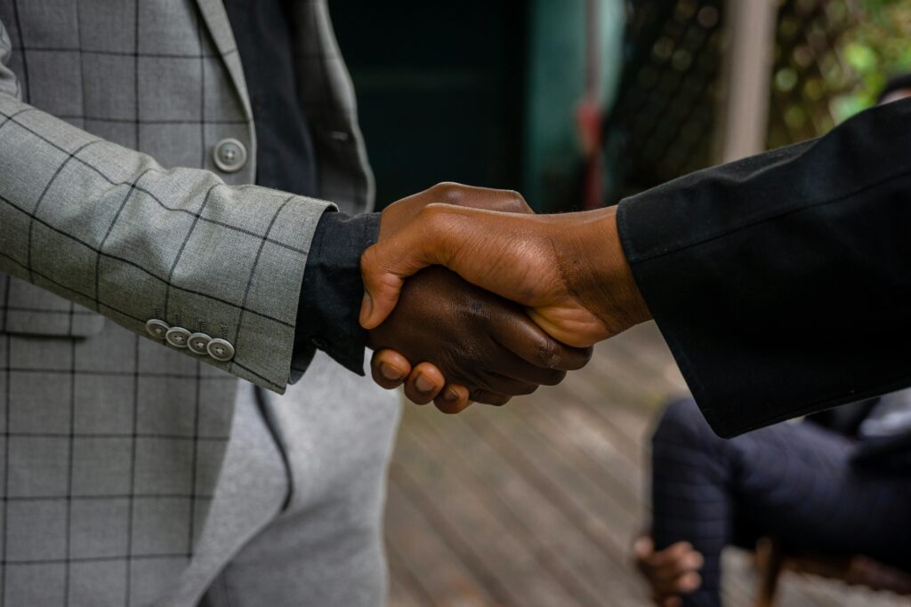 Close-up of two professionals shaking hands, symbolizing success and partnership.